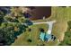 An aerial view showcases this estate home and its pristine landscaping with pond and winding driveway at 220 Epps Clark Rd, Siler City, NC 27344