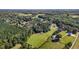 This aerial view highlights the property, bordering mature trees and pastures at 220 Epps Clark Rd, Siler City, NC 27344