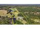 An aerial view outlining property boundaries featuring a home, pond, green fields, and surrounding woodlands at 220 Epps Clark Rd, Siler City, NC 27344