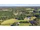 This aerial view highlights the property, bordering mature trees and pastures at 220 Epps Clark Rd, Siler City, NC 27344