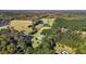 This aerial view highlights the estate, outbuildings, lush greenery, mature trees, and serene pond at 220 Epps Clark Rd, Siler City, NC 27344