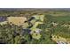 This aerial view highlights the estate, outbuildings, lush greenery, mature trees, and serene pond at 220 Epps Clark Rd, Siler City, NC 27344