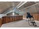 Unique attic space with metal roof, wooden walls, carpet, and an inversion table for home exercise at 220 Epps Clark Rd, Siler City, NC 27344