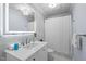 Bright bathroom featuring a sleek white vanity, illuminated mirror, and a shower with a white curtain at 220 Epps Clark Rd, Siler City, NC 27344