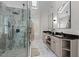 Bright bathroom with double vanity, marble shower, granite countertops and skylight provides ample natural light at 220 Epps Clark Rd, Siler City, NC 27344