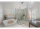 Elegant bathroom with a luxurious soaking tub, a glass enclosed shower, and natural light at 220 Epps Clark Rd, Siler City, NC 27344