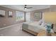 Neutral bedroom featuring a comfortable bed with a ceiling fan and natural light from window with shutters at 220 Epps Clark Rd, Siler City, NC 27344