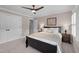 Comfortable bedroom with plush carpeting, natural light, nightstands, and tray ceiling at 220 Epps Clark Rd, Siler City, NC 27344