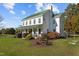 An exterior elevation showcases this charming home with an inviting porch and verdant landscaping at 220 Epps Clark Rd, Siler City, NC 27344