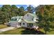Charming two-story home featuring a welcoming front porch, well-manicured lawn, and attached garage at 220 Epps Clark Rd, Siler City, NC 27344