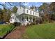 Elegant two-story house featuring a covered porch, rocking chairs, and professionally landscaped garden at 220 Epps Clark Rd, Siler City, NC 27344