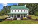 Beautiful home showcasing a welcoming front porch, lush lawn, and elegant curb appeal at 220 Epps Clark Rd, Siler City, NC 27344