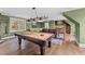 Entertaining game room with a pool table, wet bar, and comfortable seating for relaxing with guests at 220 Epps Clark Rd, Siler City, NC 27344
