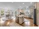 Bright open kitchen featuring an island, stainless steel appliances, and adjacent dining area at 220 Epps Clark Rd, Siler City, NC 27344