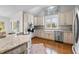 Well-appointed kitchen featuring granite countertops, stainless steel appliances, and hardwood floors at 220 Epps Clark Rd, Siler City, NC 27344