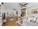 Cozy living room with hardwood floors, a stone fireplace, and abundant natural light at 220 Epps Clark Rd, Siler City, NC 27344