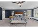 Spacious main bedroom with dark accent wall, tray ceiling, nightstands, bench, and ensuite bathroom at 220 Epps Clark Rd, Siler City, NC 27344