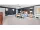 Spacious main bedroom with dark accent wall, tray ceiling, nightstands, bench, and ensuite bathroom access at 220 Epps Clark Rd, Siler City, NC 27344