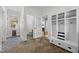 Mudroom with slate tile flooring, white storage lockers, and access to a powder room at 220 Epps Clark Rd, Siler City, NC 27344