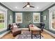 Comfortable home office with a wooden desk, leather chair, and plenty of natural light at 220 Epps Clark Rd, Siler City, NC 27344