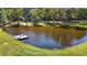 Picturesque pond with a wooden dock and benches surrounded by lush green grass and trees at 220 Epps Clark Rd, Siler City, NC 27344