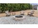 Backyard featuring a stone fire pit, gravel area, and wooden Adirondack chairs at 23 Sparkle Ln, Garner, NC 27529