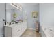 Bright bathroom with double sink vanity, storage and soaking tub at 23 Sparkle Ln, Garner, NC 27529