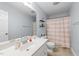 Well-lit bathroom with a single sink vanity, and neutral-toned walls and floors at 23 Sparkle Ln, Garner, NC 27529