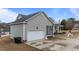 Home featuring an attached garage, screened porch, and well-maintained lawn at 23 Sparkle Ln, Garner, NC 27529