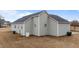 Home featuring a well-maintained exterior, basement door, and landscaping at 23 Sparkle Ln, Garner, NC 27529