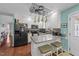 Open kitchen with granite island, stainless appliances, and eat-in counter seating at 23 Sparkle Ln, Garner, NC 27529