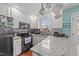 Well-appointed kitchen with stainless steel appliances, granite countertops, and ample cabinet space at 23 Sparkle Ln, Garner, NC 27529