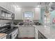 Functional kitchen boasts stainless appliances, granite counters, and stylish backsplash at 23 Sparkle Ln, Garner, NC 27529