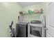 Well-equipped laundry room with modern washer, dryer, and shelving for storage at 23 Sparkle Ln, Garner, NC 27529