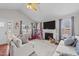 Bright living room featuring a fireplace, vaulted ceilings, and cozy decor at 23 Sparkle Ln, Garner, NC 27529
