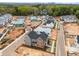 Street view of new gray and brick home, with construction taking place in the surrounding neighborhood at 2623 Marchmont St, Raleigh, NC 27608
