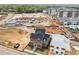 New two-story home with gray and brick exterior, manicured lawn, and construction in the neighborhood at 2623 Marchmont St, Raleigh, NC 27608