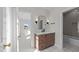Well-lit bathroom featuring wood cabinet vanity, marble countertop, black accents, and an open doorway to the bedroom at 2623 Marchmont St, Raleigh, NC 27608