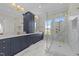 Luxurious bathroom features marble floors, double vanity with custom cabinets, and frameless glass shower at 2623 Marchmont St, Raleigh, NC 27608