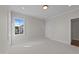 Neutral bedroom features neutral carpet, a large window, and access to other rooms at 2623 Marchmont St, Raleigh, NC 27608