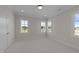 Bright, carpeted bedroom with three windows and white trim, offering ample natural light and closet space at 2623 Marchmont St, Raleigh, NC 27608