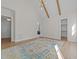 Spacious bedroom featuring vaulted ceilings, exposed beams, and adjacent bathroom access at 2623 Marchmont St, Raleigh, NC 27608