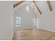 Bedroom features exposed beams, hardwood floors, and many windows at 2623 Marchmont St, Raleigh, NC 27608