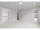 Clean bedroom featuring multiple doorways and white design with hardwood floors at 2623 Marchmont St, Raleigh, NC 27608