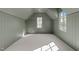 Spacious bonus room with wainscotting, neutral carpet and ample natural light, perfect for versatile use at 2623 Marchmont St, Raleigh, NC 27608