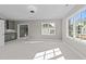 Cozy bonus room boasts soft carpet, recessed lights, windows for ample sunlight, and a convenient wet bar at 2623 Marchmont St, Raleigh, NC 27608