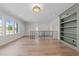 Spacious bonus room featuring hardwood floors, built-in shelves, and windows for plenty of natural light at 2623 Marchmont St, Raleigh, NC 27608