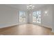 Airy dining room with hardwood floors, elegant chandelier, and ample natural light at 2623 Marchmont St, Raleigh, NC 27608