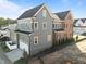 Aerial view of a two-story home with gray siding and a brick accent, highlighting its unique architectural details at 2623 Marchmont St, Raleigh, NC 27608