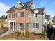 Elegant brick and gray two-story home with dark shutters and landscaped front yard at 2623 Marchmont St, Raleigh, NC 27608